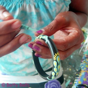 Nyoman's beautiful hands add a layer of design to one of the Hobie Bohemian Bangles. Each one is painted by hand by the Balinese Artisans of Betty B. for the Hobie Project.     