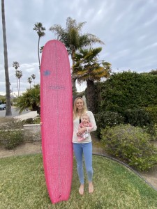 pink surf board and Sierra Partridge